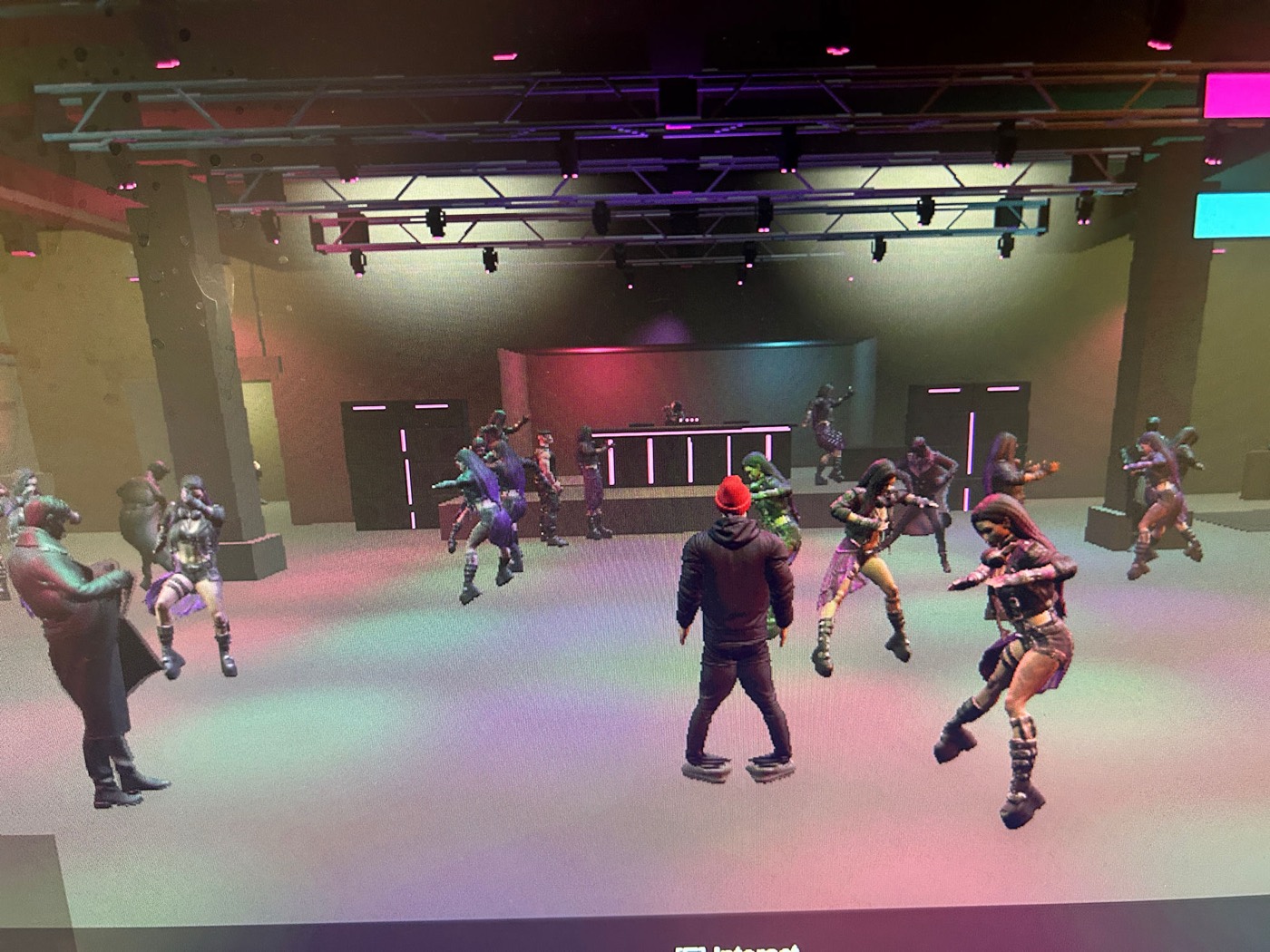 The Rave Game — reworked Bochka main room, big dancing crowd under a truss lighting rig, DJ booth at the back